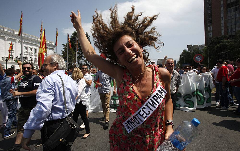 A woman dances while protesting in front of the Government building in Skopje, Macedonia.