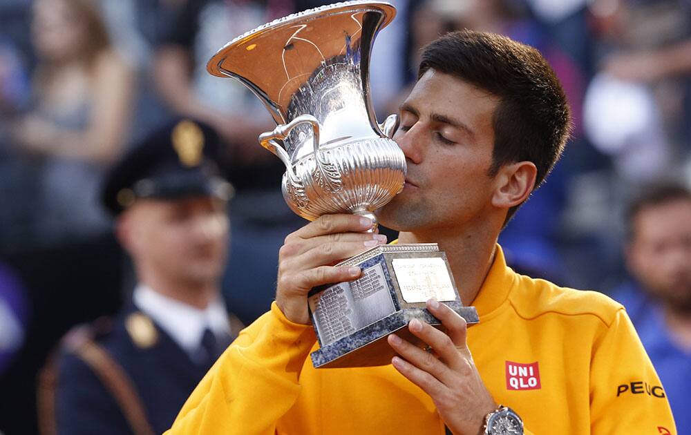 Serbia's Novak Djokovic kisses the trophy after defeating Switzerland's Roger Federer in their men's final match at the Italian Open tennis tournament, in Rome.