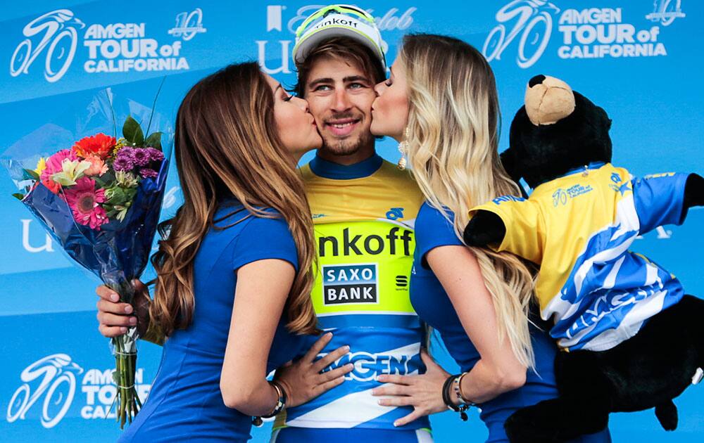 Peter Sagan, of Slovakia riding for Tinkoff-Saxo, is kissed on the podium whole being awarded the overall race leader yellow jersey at the eight final stage of the Amgen Tour of California cycling race 65.3 miles from Los Angeles to Pasadena.