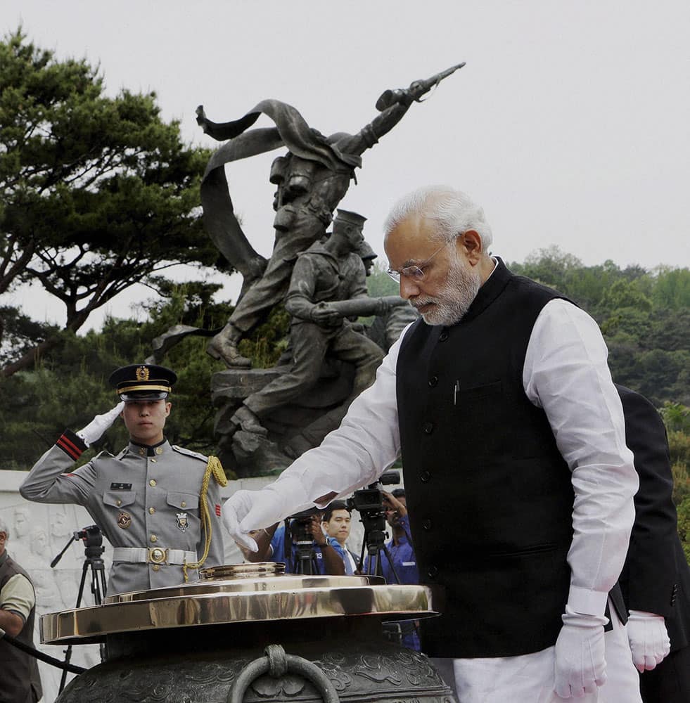 Prime Minister Narendra Modi lights incense at the National Cemetery in Seoul.