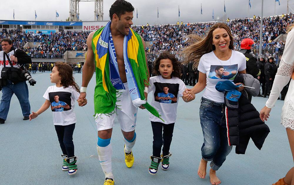 Zenit's Hulk celebrates with his family after winning the national soccer Championship after match against Ufa in St.Petersburg, Russia.