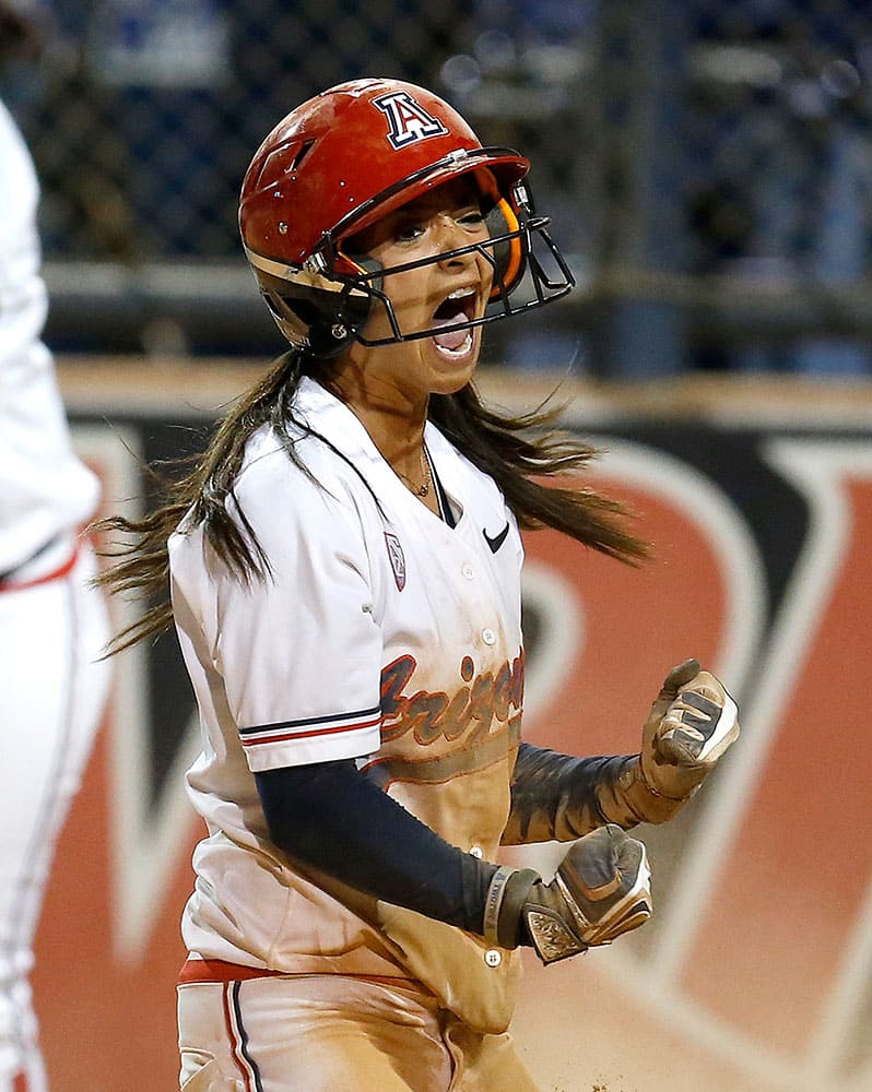 Arizona infielder Chelsea Suitos celebrates after scoring the game-winning run and defeating Minnesota 7-6 in an NCAA college softball tournament regional championship game.