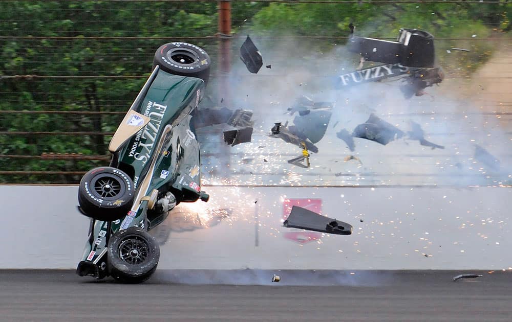 Ed Carpenter hits the wall in the second turn during practice before qualifications for the Indianapolis 500 auto race at Indianapolis Motor Speedway in Indianapolis.