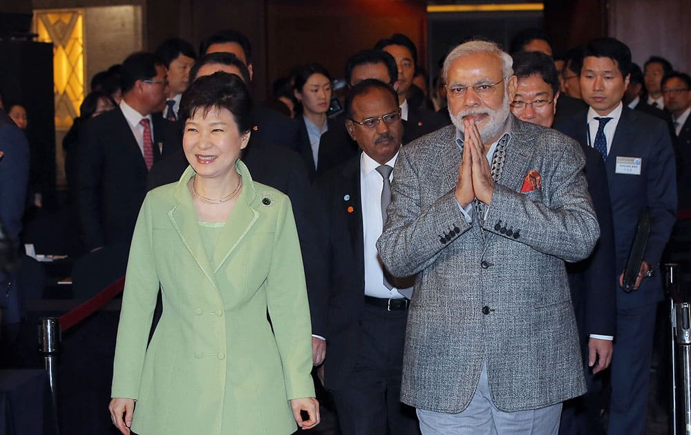 South Korean President Park Geun-hye, left, and Indian Prime Minister Narendra Modi, right, arrive at the South Korea and India CEO forum in Seoul, South Korea.