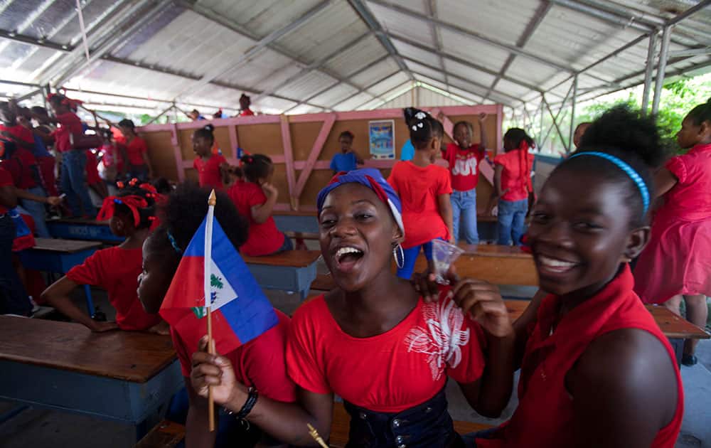 Students dance during celebrations marking Flag Day in Port-au-Prince, Haiti, Monday, May 18, 2015. Haitians celebrated the 212th anniversary of the creation of their national flag.