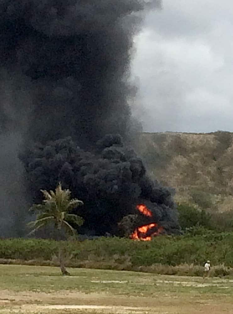 smoke rises from a Marine Corps Osprey aircraft after making a hard landing near Bellows Air Force Station near Waimanalo, Hawaii. The fatal crash of the Marine Corps' new hybridized airplane-and-helicopter aircraft during a training exercise is renewing safety concerns about the machine.