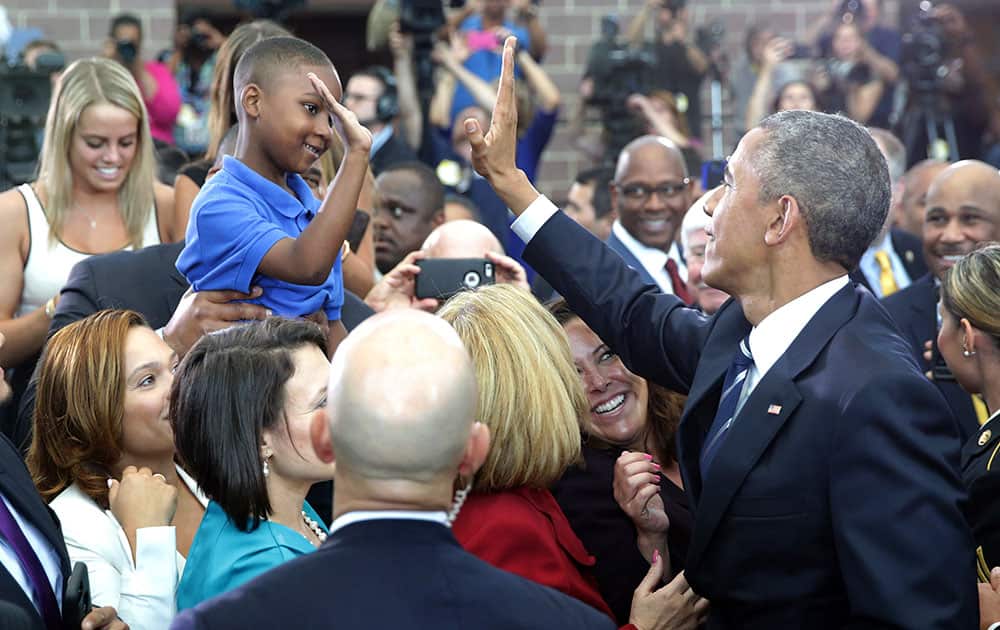 President Barack Obama high-fives Jaiden Steele, of Camden, after he spoke at the Ray & Joan Kroc Corps Community Center, in Camden, N.J.