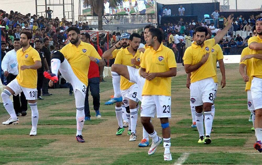 Bollywood actors Ranbir Kapoor, Abhishek Bachchan with All Star Football Club teammates warm up before an exhibition football match against Surat football Team, for underprivileged children in Surat.