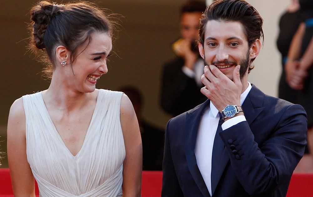 Actress Charlotte Le Bon, left, laughs as she stands alongside actor Pierre Niney upon arrival for the screening of the film Inside Out at the 68th international film festival, Cannes.