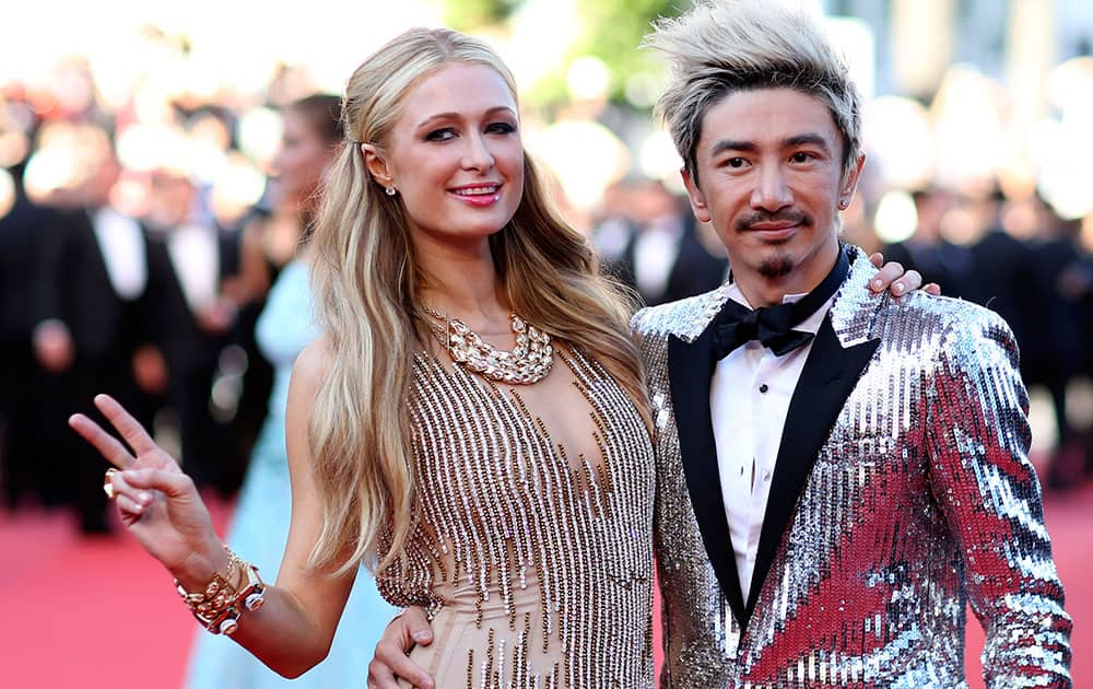 Heiress Paris Hilton, left, poses for photographers with an unidentified guest as she arrives for the screening of the film Inside Out at the 68th international film festival, Cannes.