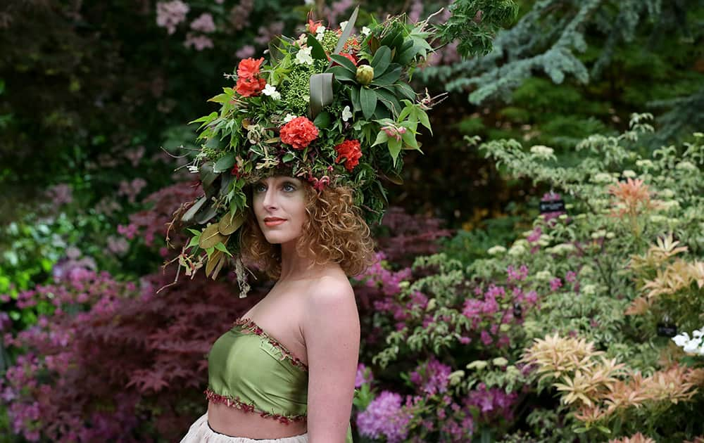 Katherine Warwick Adkins wears a floral hat and dress made by floral stylists Okishima & Simmonds at the Chelsea Flower Show in London.