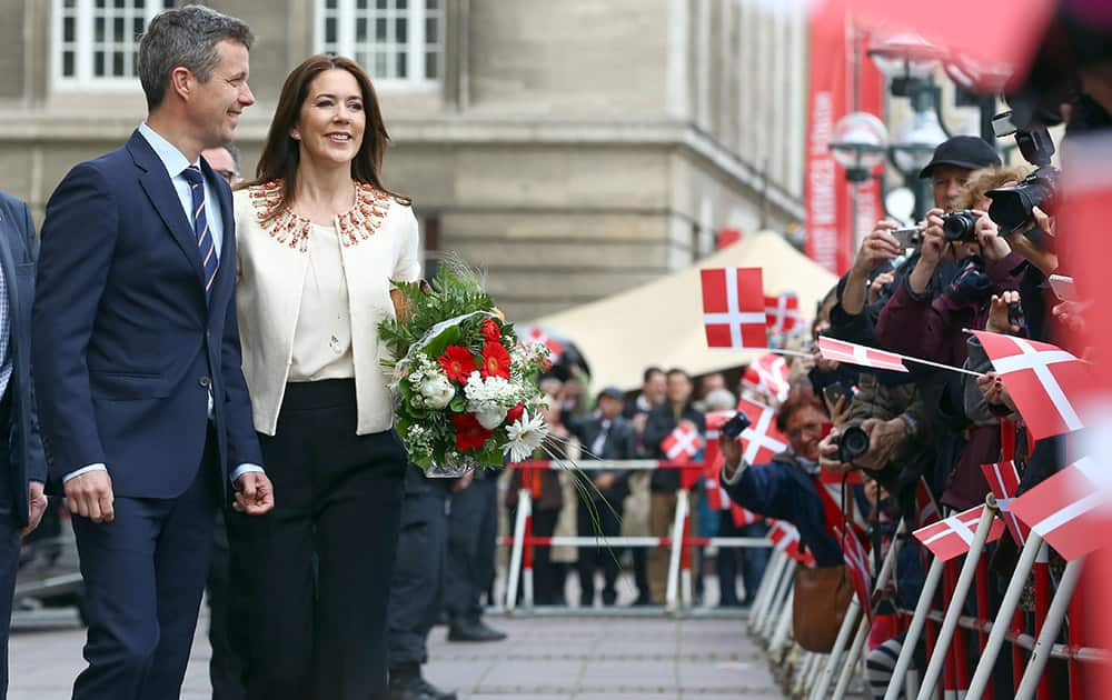 People wave Danish flags as Frederik, Crown Prince of Denmark and his wife Crown Princess Mary arrive at the city hall in Hamburg, Germany. The Danish royal couple is in Germany on a working visit entitled 'Danish Living' until May 21, 2015. 