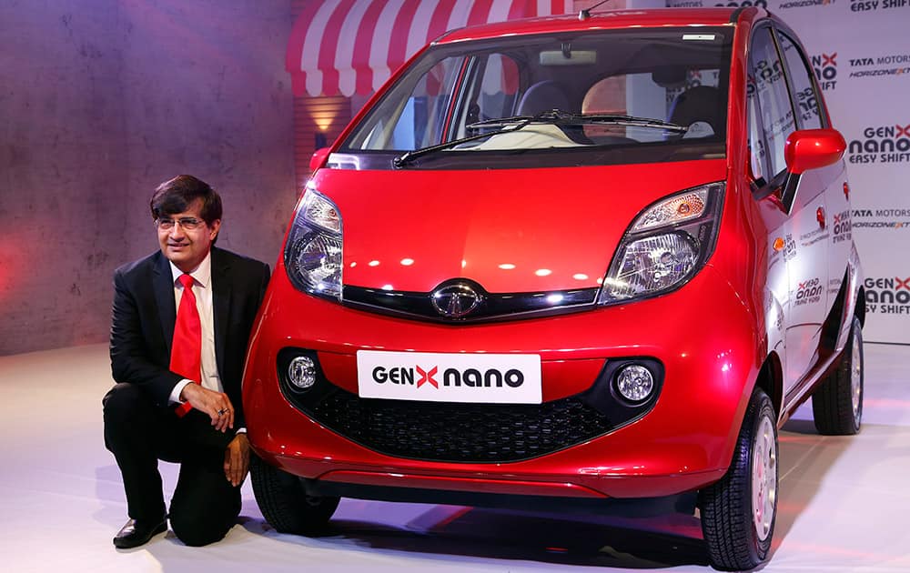 President of Tata Motors’ Passenger Vehicles Business Unit Mayank Pareek poses with the newly launched GenX Nano car in Mumbai. The GenX Nano costs between Indian Rupees 1,99,000 – 2,89,000 (US$ 3315-4815). 
