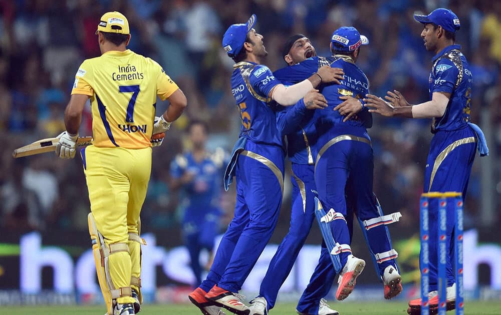 Mumbai Indians player Harbhajan Singh with team mates celebrate the wicket of Chennai Super Kings Captain MS Dhoni during the first qualifier match of IPL in Mumbai.