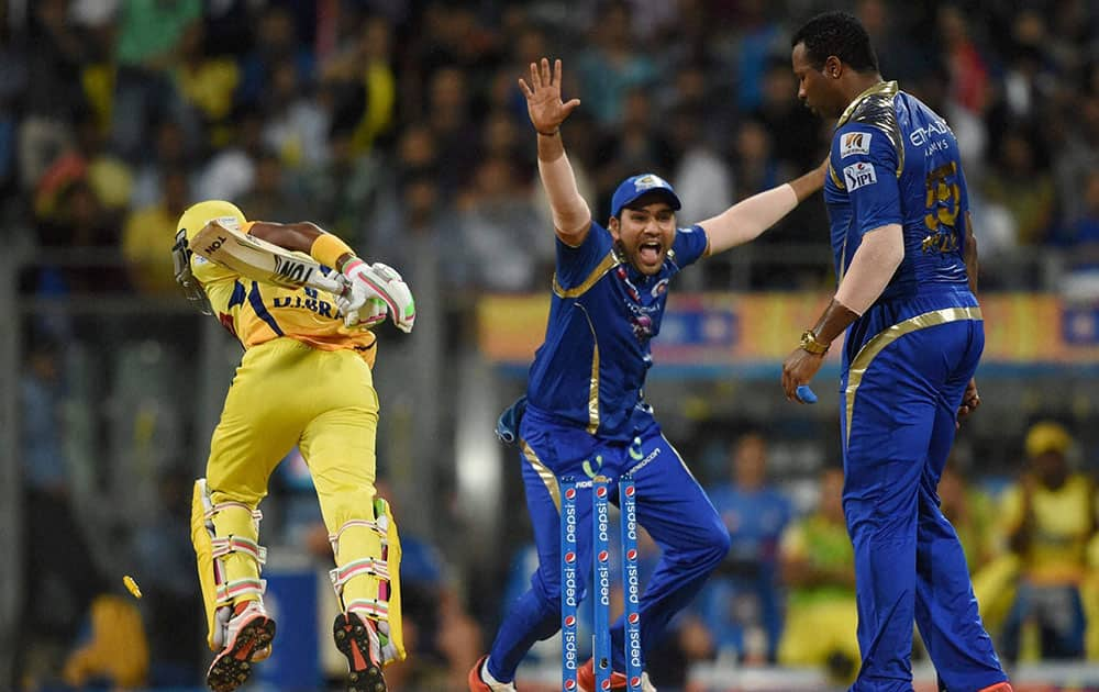 Mumbai Indians player Rohit Sharma celebrate the wicket of CSKs Dwayne Bravo run out by Kieron Pollard during the first qualifier match of IPL in Mumbai.