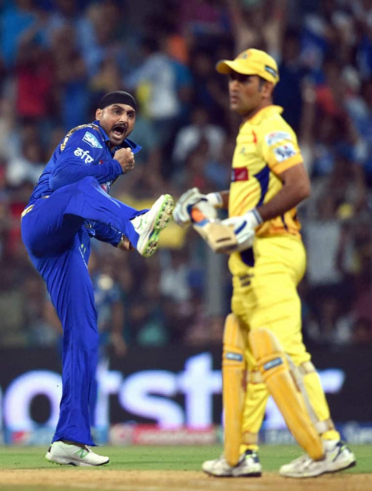 Mumbai Indians player Harbhajan Singh celebrates the wicket of Chennai Super Kings Captain MS Dhoni during the first qualifier match of IPL in Mumbai.