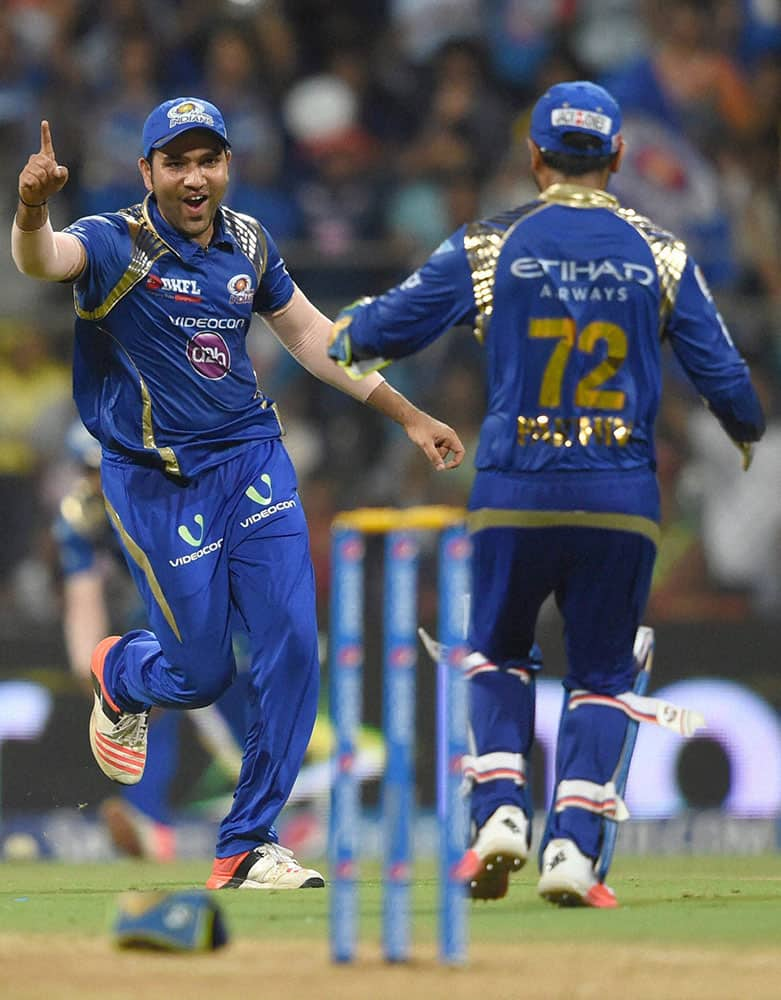 Mumbai Indians player Rohit Sharma and Parthiv Patel celebrate the wicket of CSKs Dwayne Bravo during the first qualifier match of IPL in Mumbai.