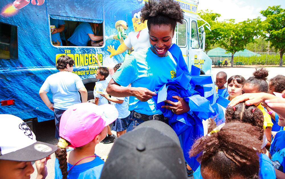 Lucky fans receive free reusable tote bags from the SpongeBob Treat Truck, 2015 at Zoo Miami in Miami, Florida to celebrate World Oceans Day and the home entertainment debut of the blockbuster hit film The SpongeBob Movie: Sponge Out Of Water. 