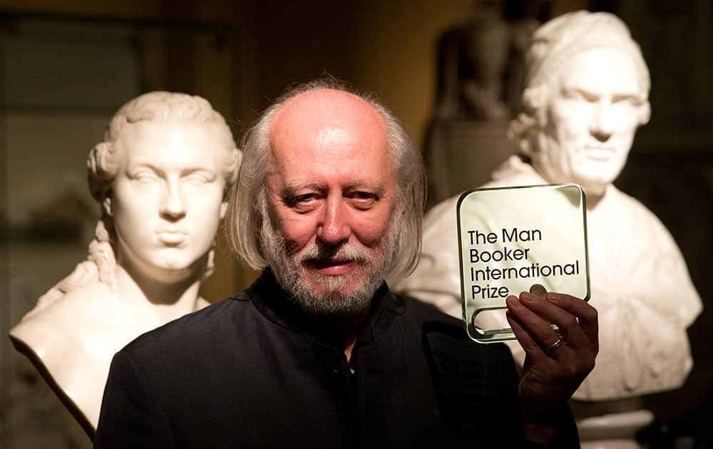 Hungary's Laszlo Krasznahorkai, the winner of the Man Booker International Prize, poses for photographers with the trophy shortly after the award ceremony at the Victoria and Albert Museum in London.