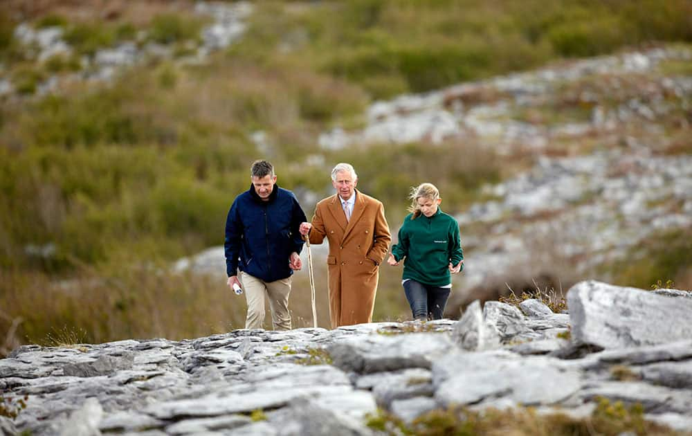 Britain's Prince Charles, center, talks with Bridget Barry, right, Burren BEO trust and Dr Brendan Dunford, Burren Farming for Conservation Programme's Project Manager during a visit to the Burren in County Clare, Ireland.