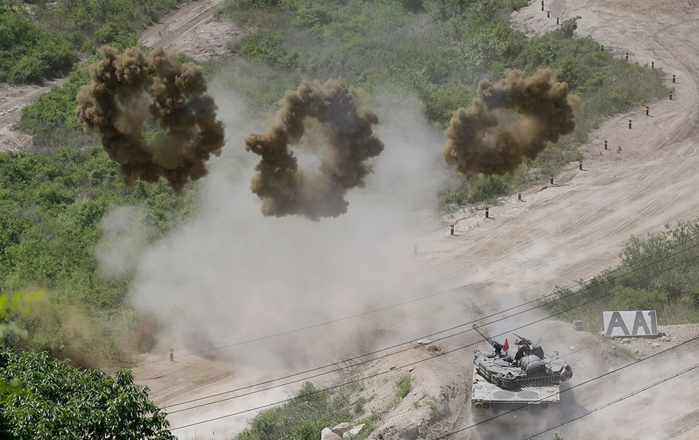 A South Korean army K-1 tank shoots smoke screens to demonstrate during a media tour of the front line between South Korea and North Korea border at a fire training field in Cheorwon, South Korea.