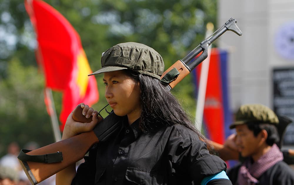 A Cambodian student of Royal University of Fine Arts performs during a reenactment of torture and execution committed by the Khmer Rouge during their reign of terror in the 1970s to mark the annual Day of Anger at Choeung Ek, a former Khmer Rouge 