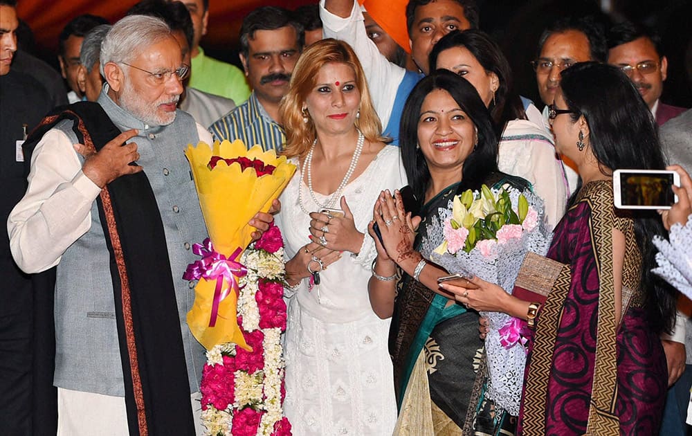 Prime Minister Narendra Modi is greeted by BJP workers upon his arrival at Palam Airport after his three-nation tour.