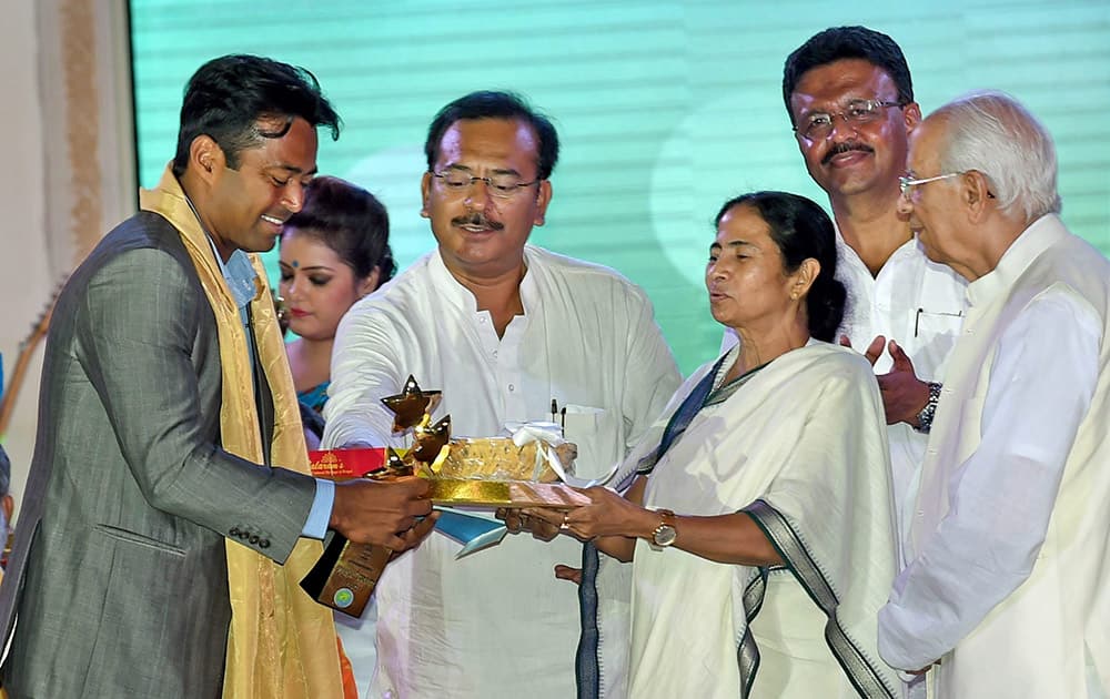 Ace Tennis player Leander Paes receives Banga Bibhusan 2015 award from West Bengal Chief Minister Mamata Banerjee in Kolkata.