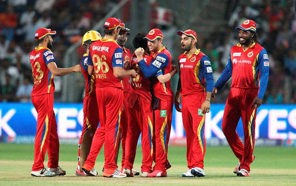 Yuzvendra Chahal of the Royal Challengers Bangalore and AB De Villiers celebrate getting Ajinkya Rahane of Rajasthan Royals wicket during the eliminator match of the IPL 2015 at the MCA International Stadium in Pune.