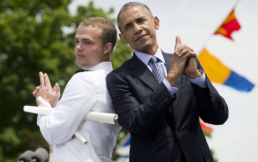 President Barack Obama and Ensign Robert Huntley McConnel strike a pose after he received his diploma and commission at the U.S. Coast Guard Academy graduation, in New London, Conn. 