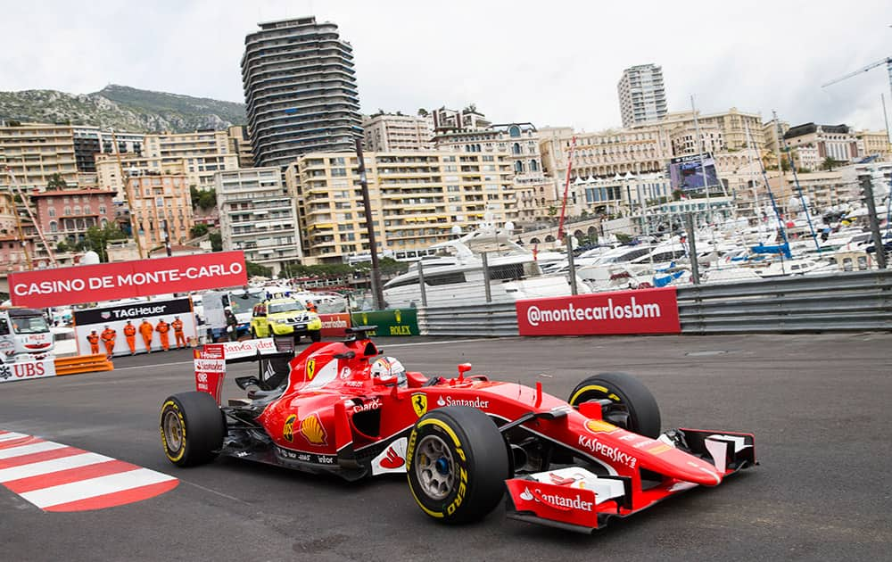 Ferrari driver Sebastian Vettel of Germany steers his car during the first practice session at the Monaco racetrack, in Monaco.