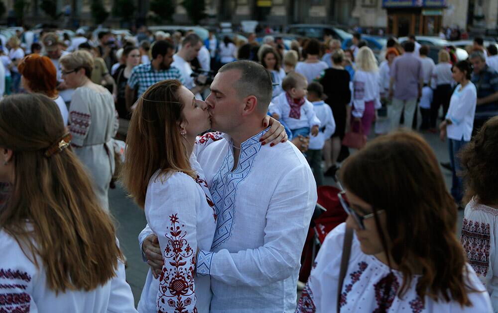 A couple dressed in traditional Ukrainian garment known as the vyshyvanka shares a kiss at a gathering in the center of Kiev, Ukraine.