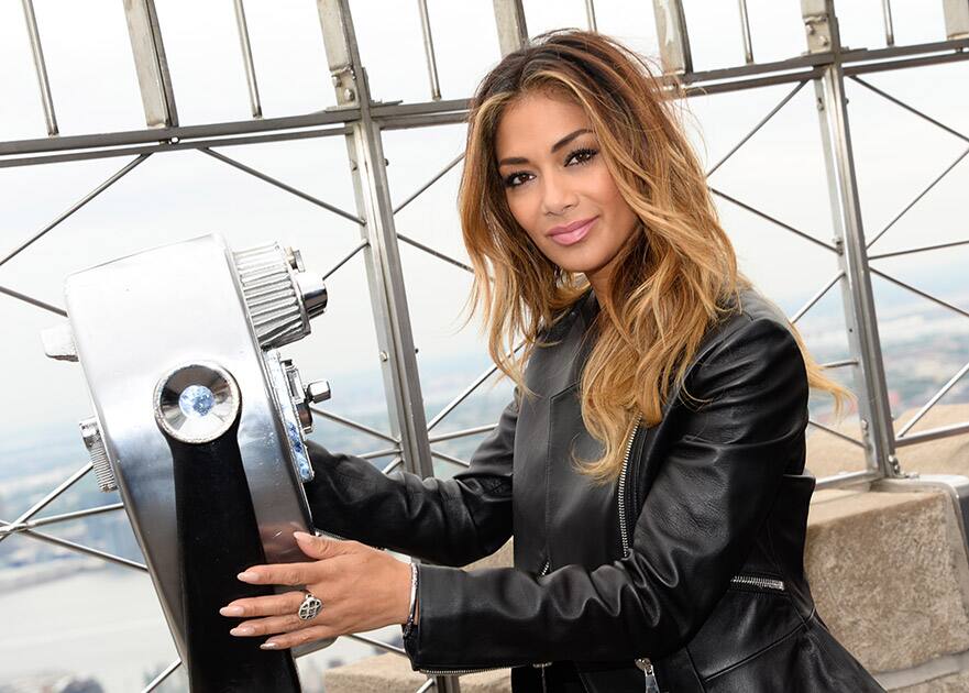 Singer Nicole Scherzinger poses on the observation deck following the lighting of the Empire State Building in honor of NBC's Red Nose Day entertainment charity event, in New York.