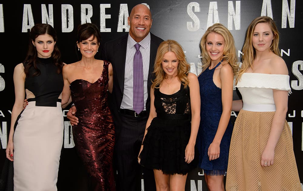 US actress, Alexandra Daddario, left, US actress, Carla Gugino, US actor, Dwayne Johnson, Australian singer, Kylie Minogue, US actress, Breanne Hill and Australian actress Morgan Griffin pose for photographers at the world premiere of San Andreas at a central London cinema.