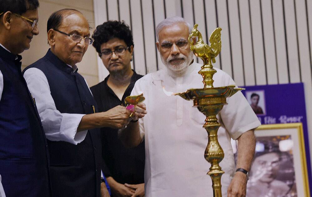 Prime Minister Narendra Modi with BJP leader CP Thakur lights the lamp during a function to celebrate golden jubilee of Ramdhari Singh Dinkars works Sanskriti Ke Chaar Adhyay and Parshuram Ki Prateeksha in New Delhi on Friday. Bindeshwar Pathak of Sulabh Internation and lyricist Prasoon Joshi are also seen.