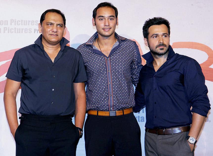 Former Indian cricketer Mohammad Azharuddin with his son Asaduddin ( C ) and Bollywood actor Emraan Hashmi pose at the preview of film Azhar.