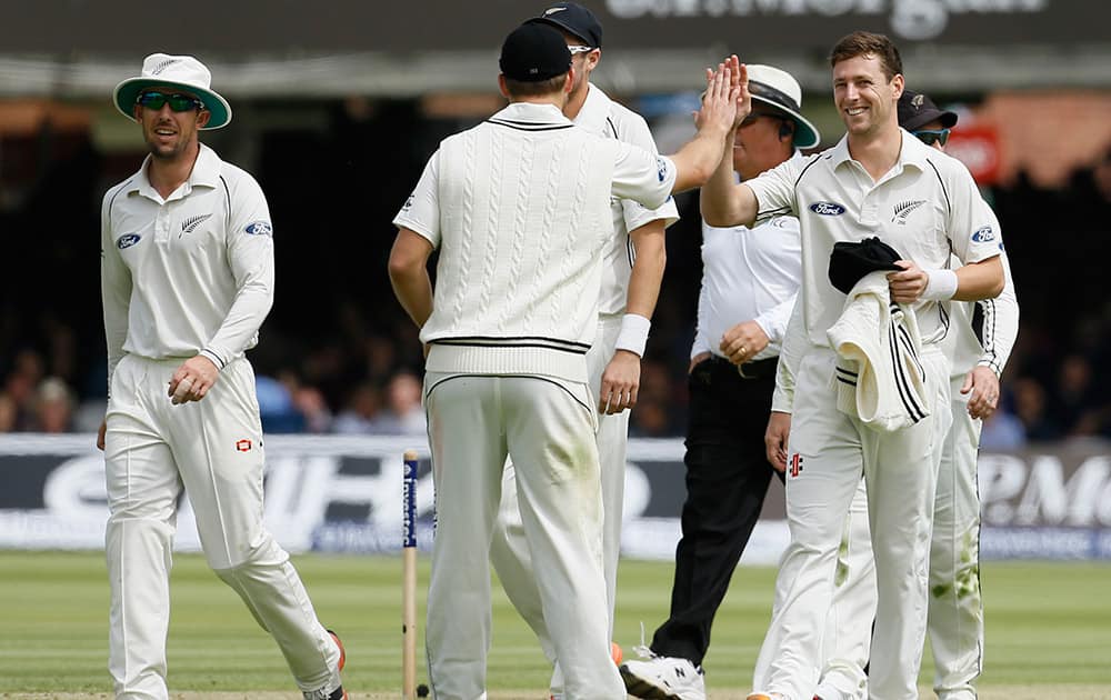 New Zealand's Matt Henry is congratulated after taking the final England wicket of James Anderson in their first inning during play on the second day of the first Test match at Lord's cricket ground in London.