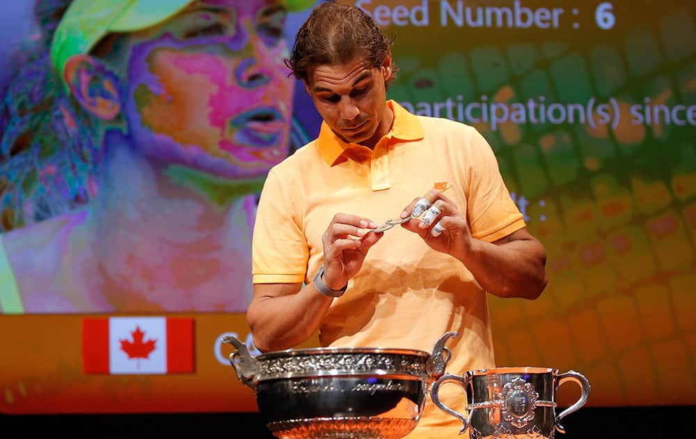 Defending champion Spain's Rafael Nadal picks a token during the draw for the French Tennis Open at the Roland Garros stadium in Paris. 