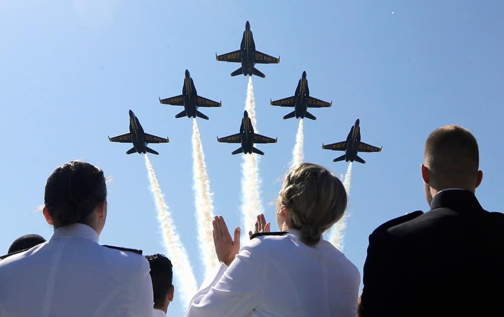 The Blue Angels flight demonstration team flies over graduating members of the U.S. Naval Academy during a graduation and commissioning ceremony in Annapolis, Md.