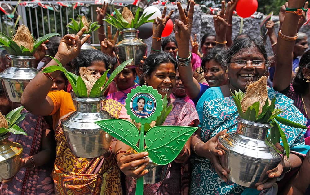 Supporters of AIADMK leader Jayaram Jayalalitha celebrate in front of her residence as news emerged that she could be sworn-in as the state chief minister on Saturday, in Chennai.