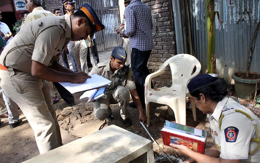 Police officers investigate the spot after a firing at the Film City at Goregaon East in Mumbai. The firing incident took place very close to where Megastar Amitabh Bachchan was shooting.