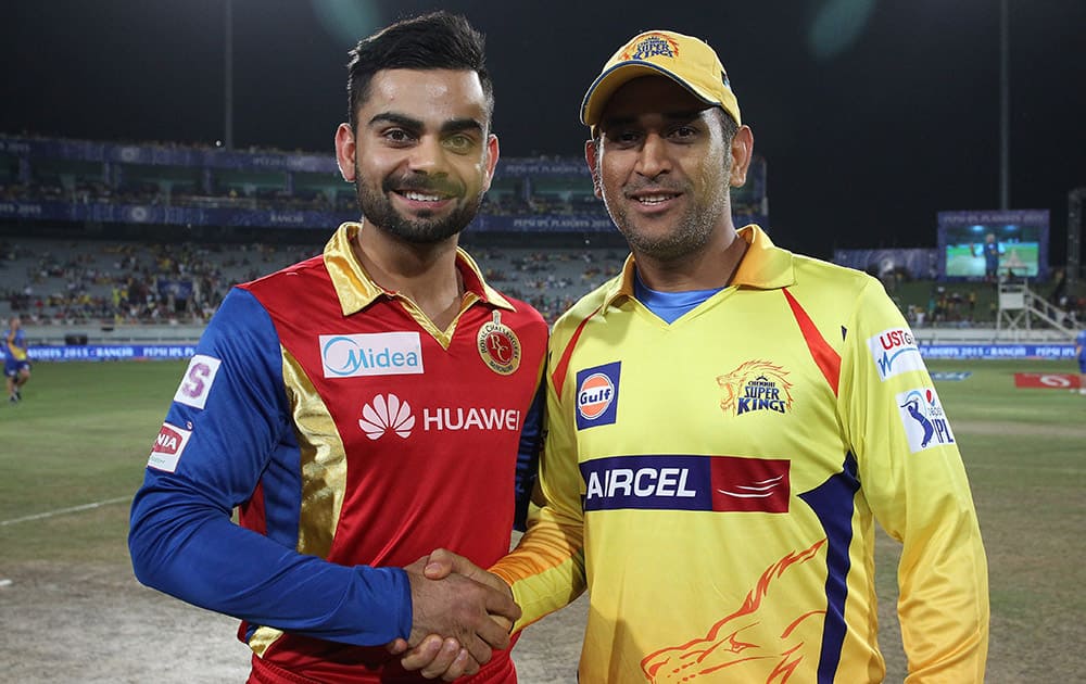 Royal Challengers Bangalore captain Virat Kohli and Chennai Super Kings Captain MS Dhoni shake hands after the toss of the 2nd qualifier match of the IPL 8 in Ranchi.