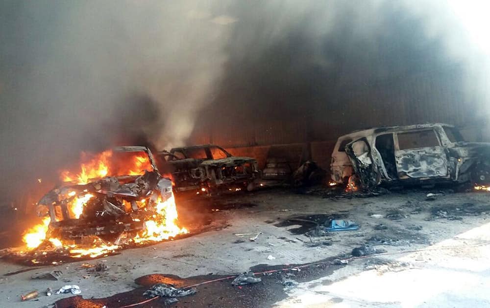 Vehicles burn, that authorities say caught fire during a gunbattle, in a warehouse at Rancho del Sol, near Ecuanduero, in western Mexico