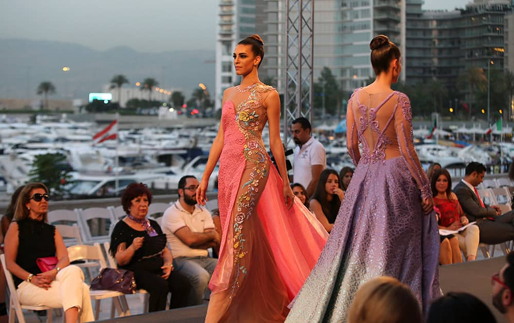 Models display creations by Emirati designer Mona al-Mansouri of her Spring-Summer 2015 fashion show during the summer fashion week at Saint George Yacht Club in Beirut, Lebanon.