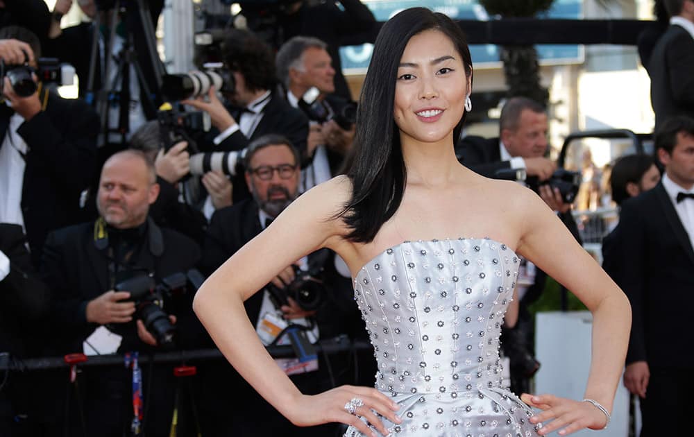 Model Liu Wen pose for photographers upon arrival for the screening of the film The Little Prince at the 68th international film festival, Cannes.