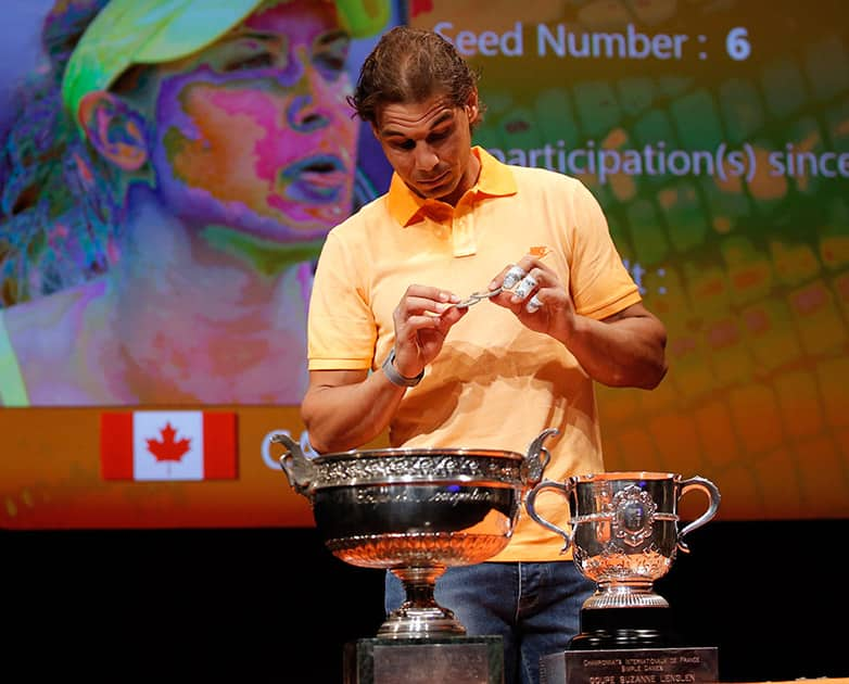 Defending champion Spain's Rafael Nadal picks a token during the draw for the French Tennis Open at the Roland Garros stadium.