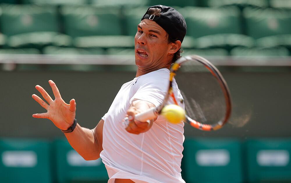 Defending champion Spain's Rafael Nadal returns a ball during a training session for the French Tennis Open at the Roland Garros stadium.