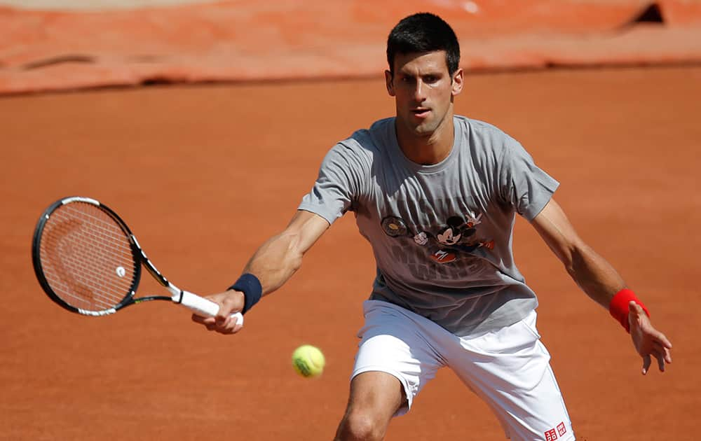 Serbia's Novak Djokovic returns the ball during a training session for the French Tennis Open at the Roland Garros stadium.