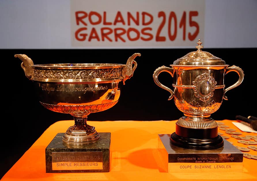 The men singles trophy, left, and the women signes trophy are pictured before the draw for the French Tennis Open at the Roland Garros stadium.