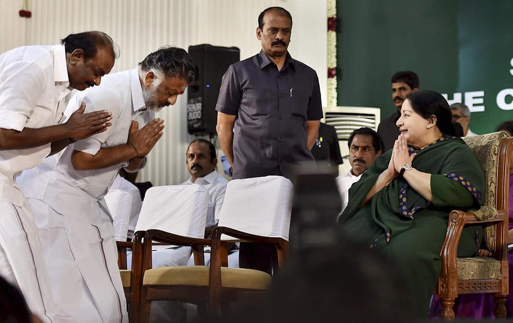 AIADMK supremo J Jayalalithaa is greeted by senior leaders O Panneerselvam and Natham Viswanathan during her swearing-in ceremony as Chief Minister of Tamil Nadu at Madras University Centenary Auditorium in Chennai.